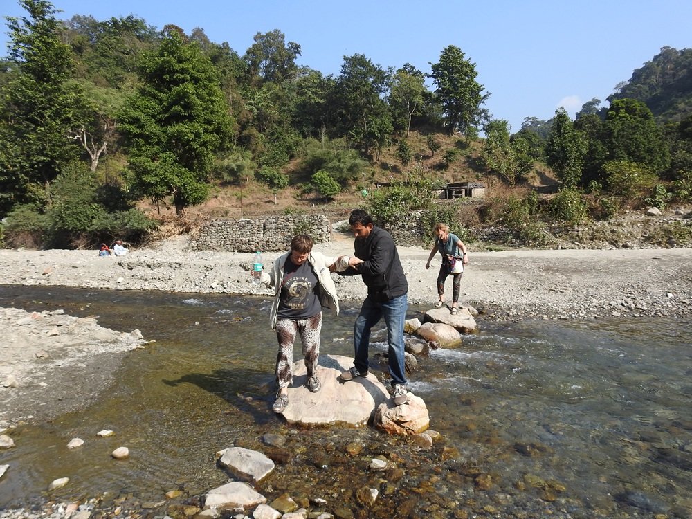 Crossing a Himalayan stream during a forest walk